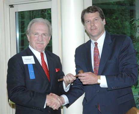 John Fredrickson passes the gavel to Bill Parker.